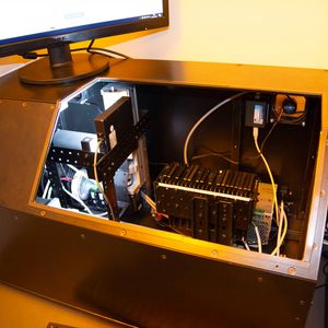 Open robot case with internal components and monitor above