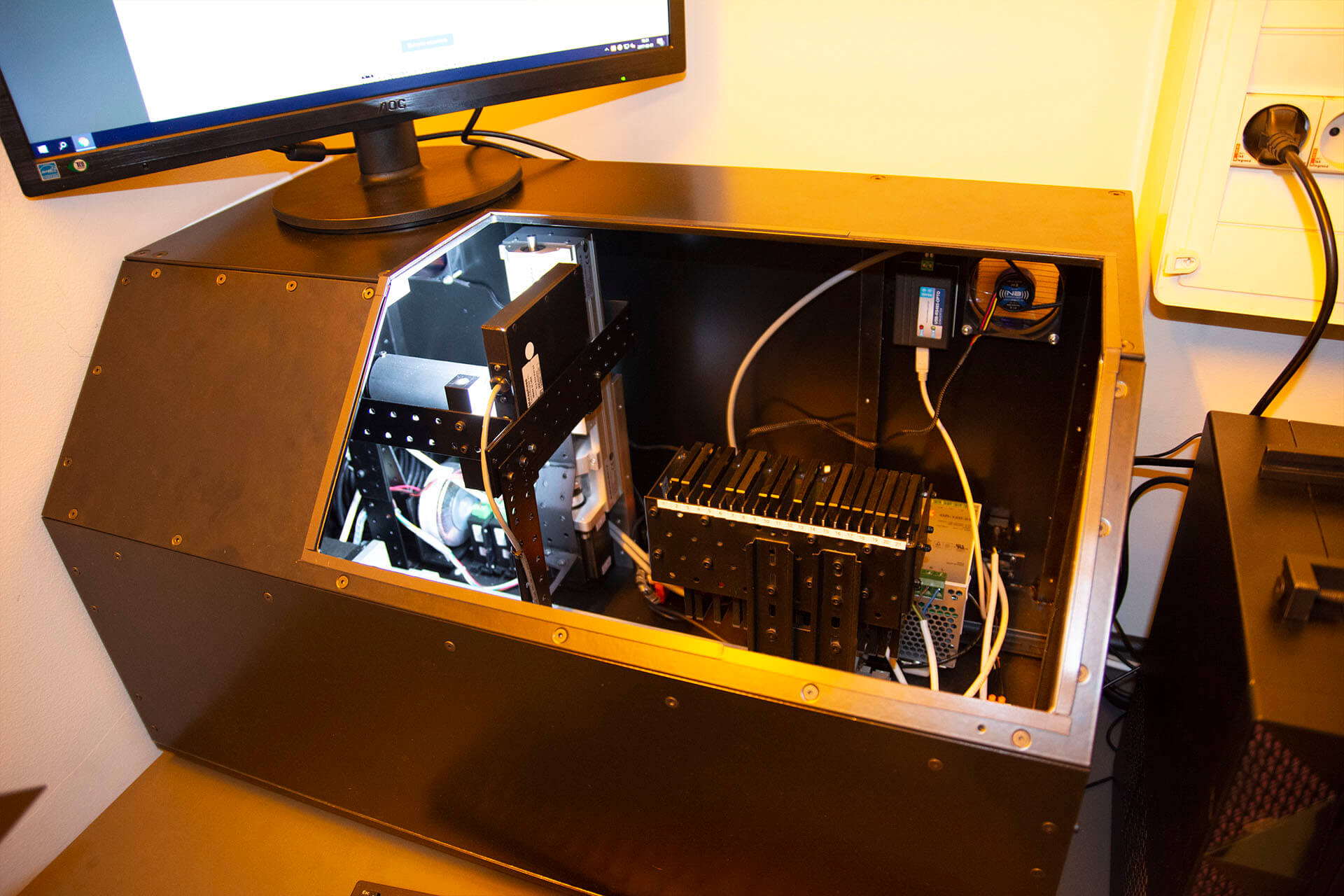 Open robot case with internal components and monitor above